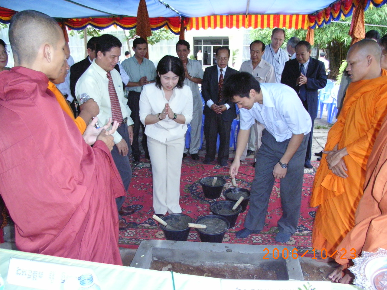 Photo 1. Pouring cement at Ground-Breaking Ceremony by JICA Expert, the officer of National Statistics Center of Japan. This ceremony was broadcasted through Cambodian TV and was appeared on the article of Cambodian newspaper.