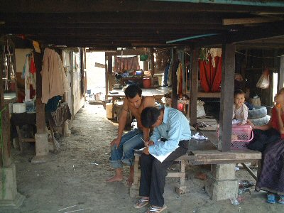 Photo 1. Enumerator visits and interviews each household, and fills in the questionnaire.