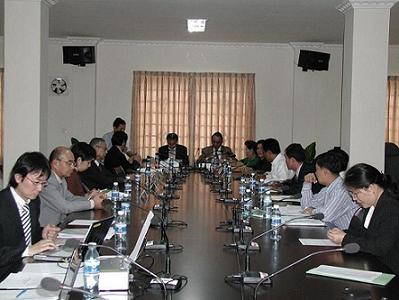 Photo 1. Signing the Minutes on the Mid-term Evaluation for Phase II.